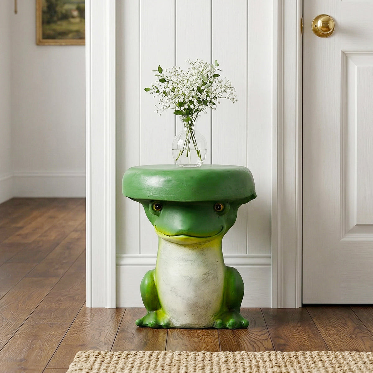 Cute green frog statue used as an elegant indoor plant stand holding a vase of white flowers.