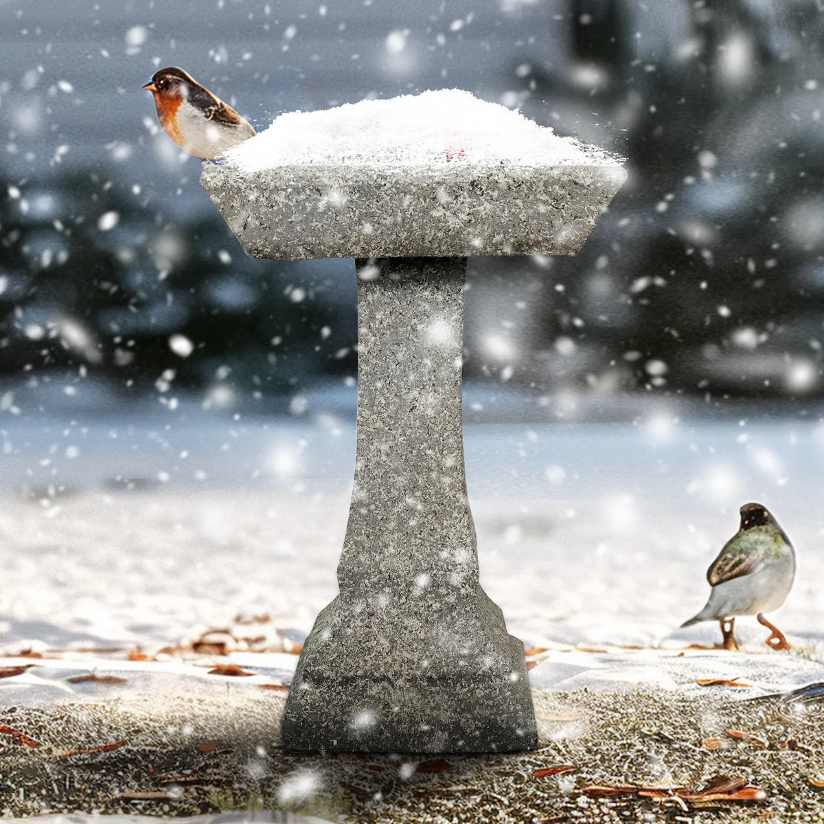 Durable concrete birdbath standing in the snow, demonstrating weather-resistant cast construction.