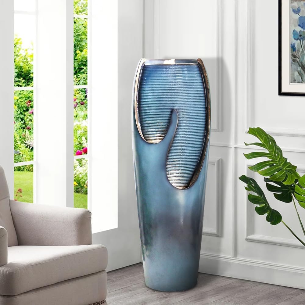 Indoor decorative turquoise jar fountain adding sophisticated charm to an entryway