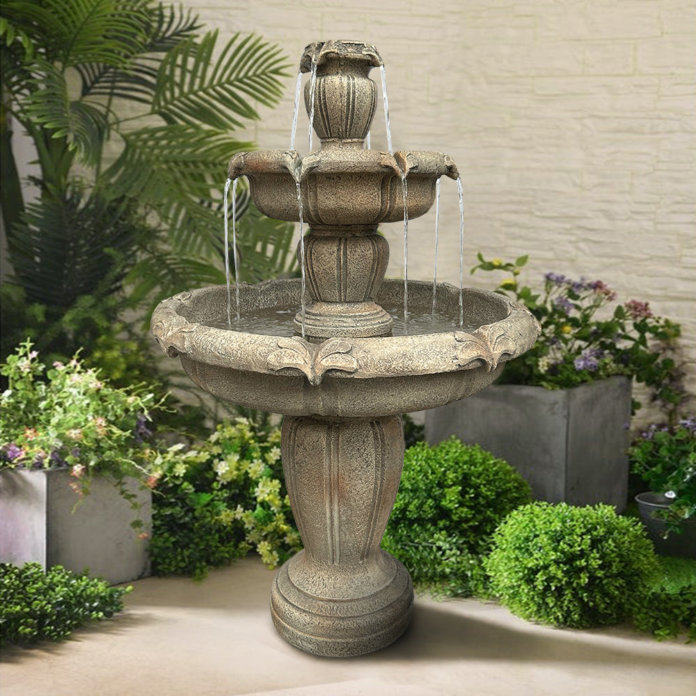 Large 3-tier concrete fountain serving as a stunning centerpiece on a modern outdoor patio.