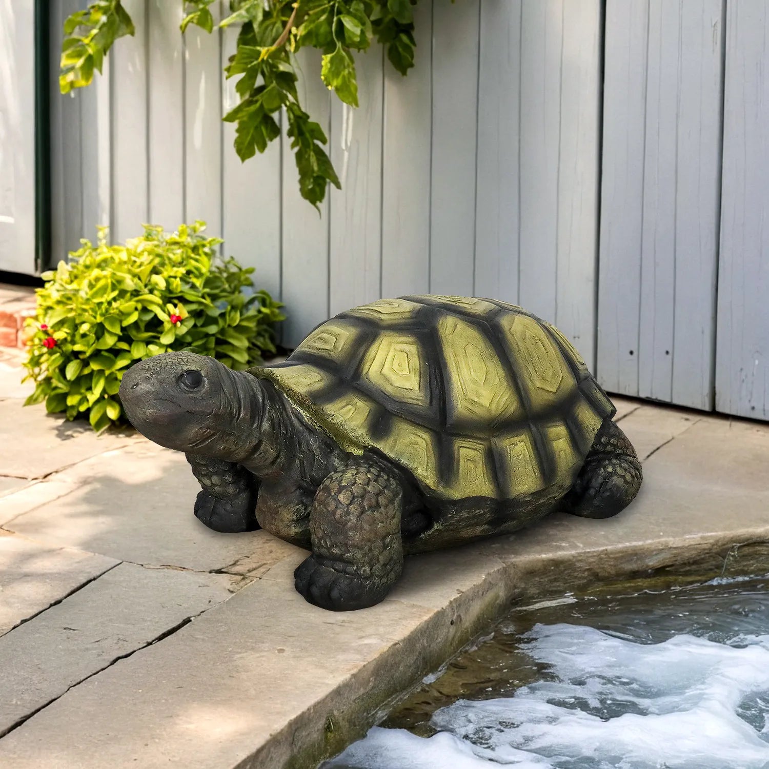 Large 34.2-inch fiber reinforced concrete turtle statue placed on a modern stone patio near water.