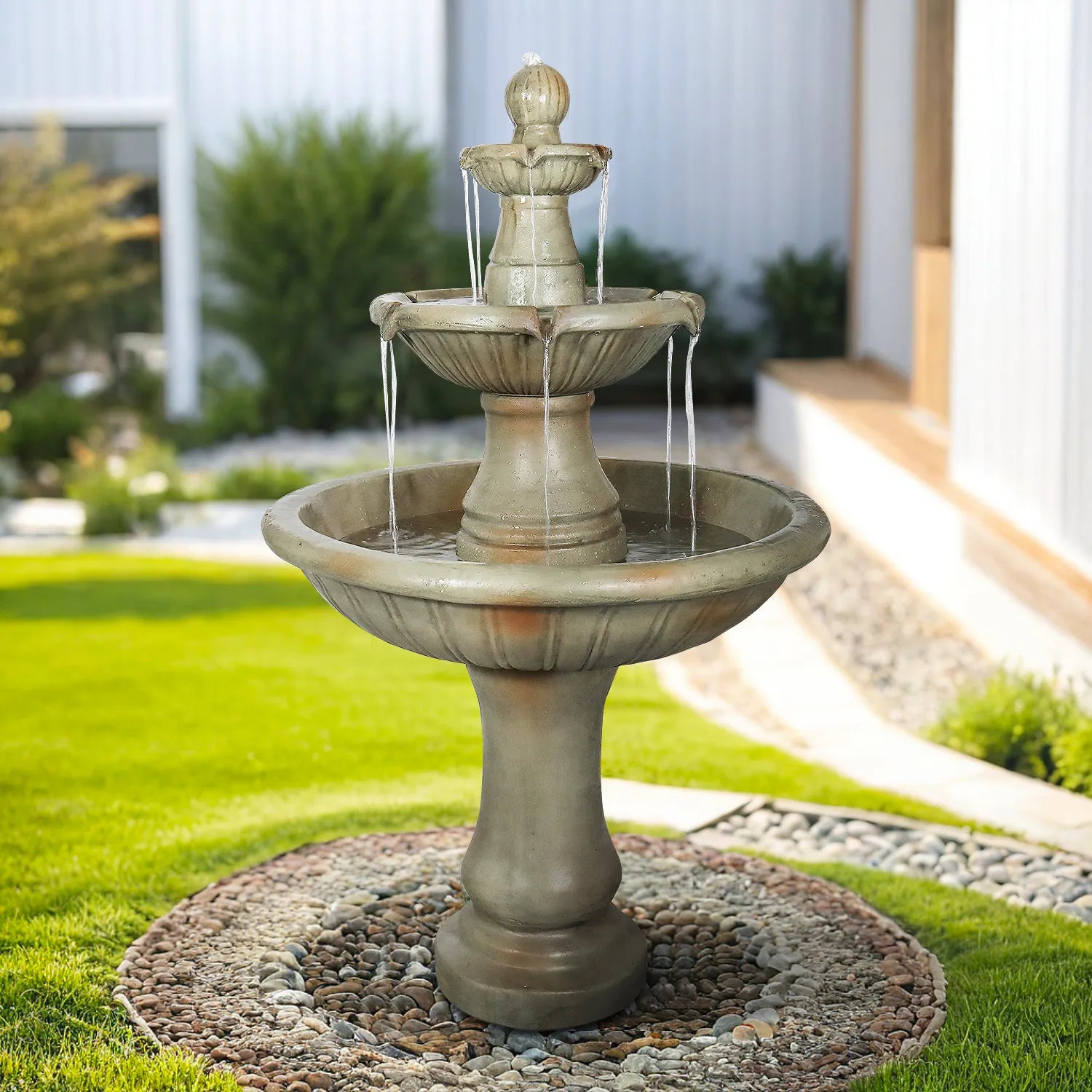 Large stone-look 3-tier waterfall fountain on a lush green lawn