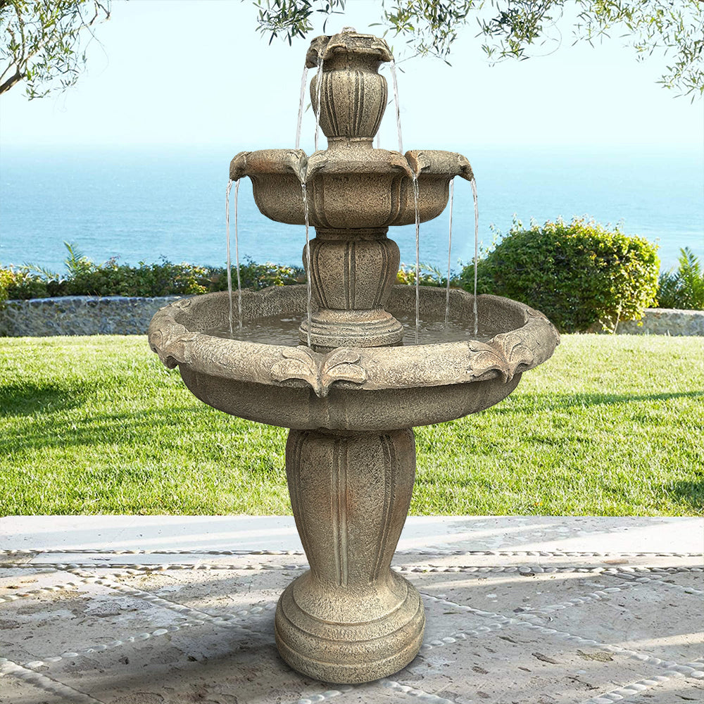 Magnificent 48H concrete garden water fountain overlooking a scenic ocean background.