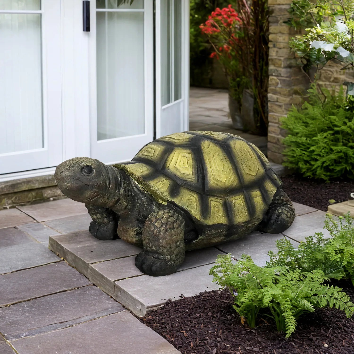 Realistic concrete tortoise garden sculpture as a welcome statue at a home entryway.