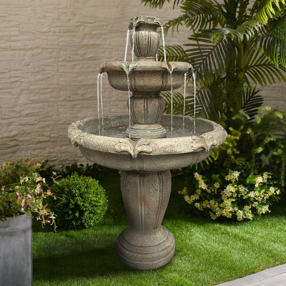 Sturdy cascading floor fountain bringing soothing water sounds to a courtyard stone wall.