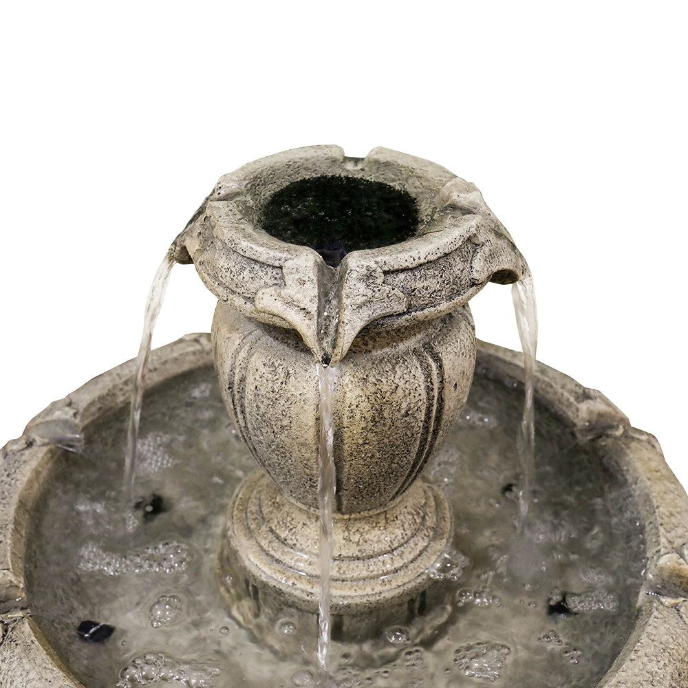 Top-down view of the water spout on the classic 3-tier concrete outdoor fountain.