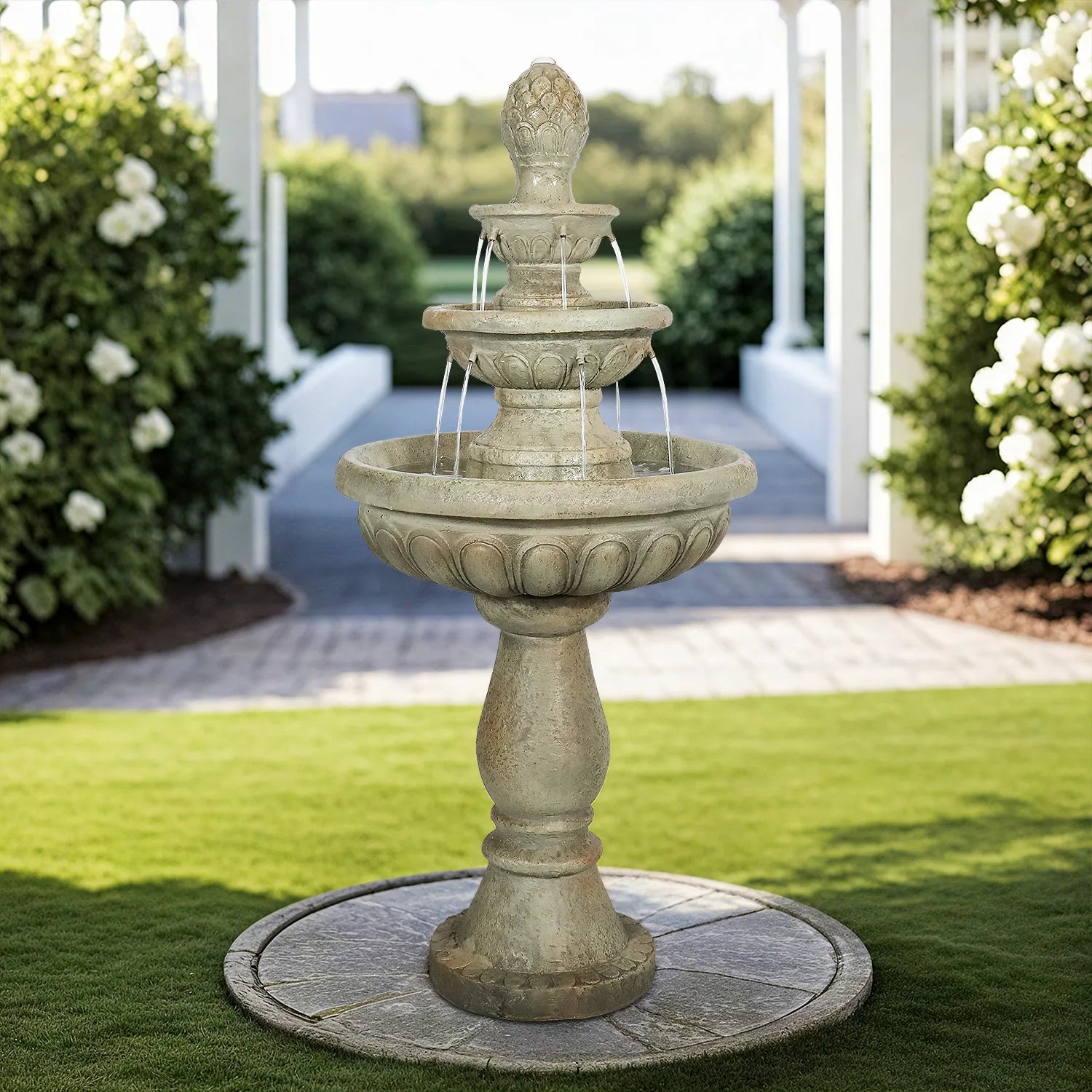 Vertical 3-tier concrete waterfall fountain as a focal point in a modern landscaped courtyard.