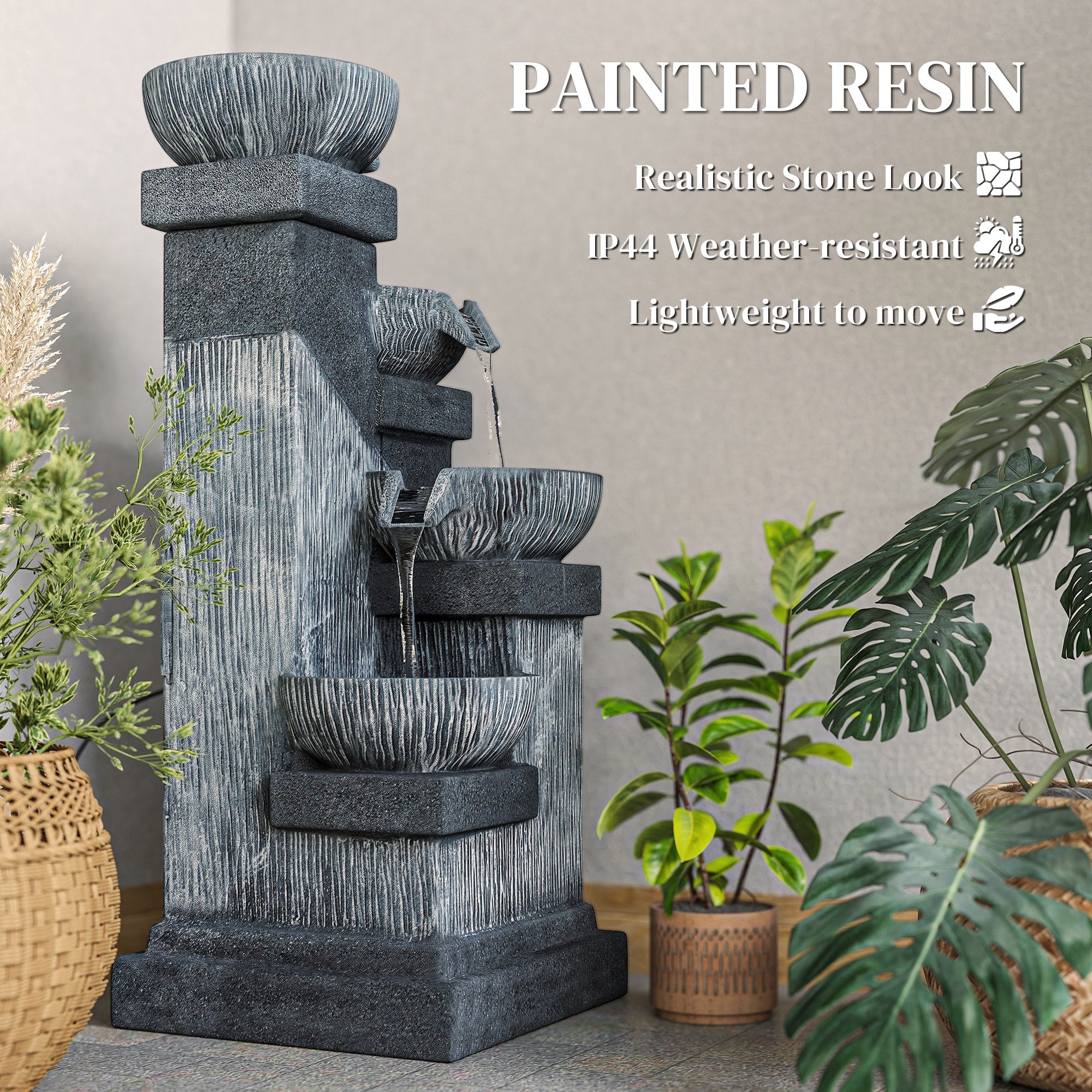 charcoal bowl tower fountain surrounded by tropical foliage