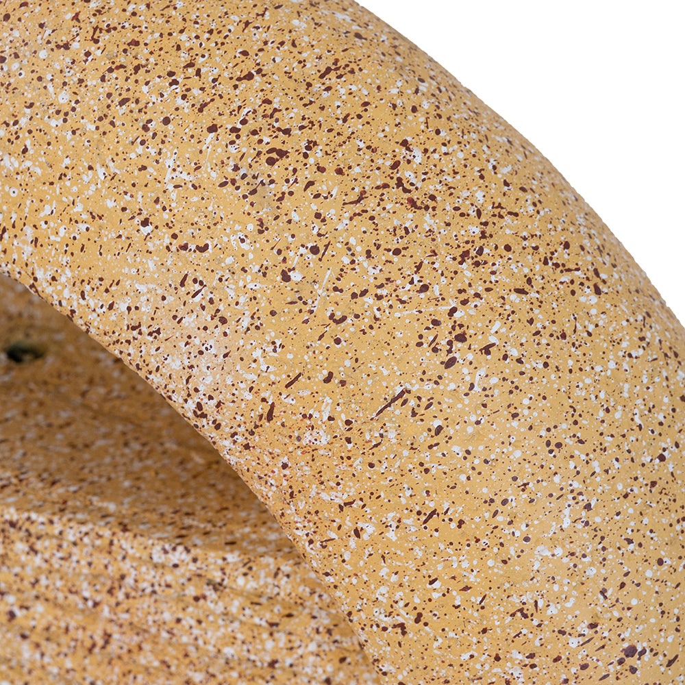 Cream cement material texture detail with brown and white aggregate speckle