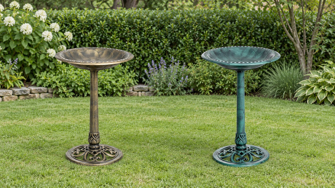 Two resin bird baths side by side on a lawn, antique bronze on the left and green verdigris on the right