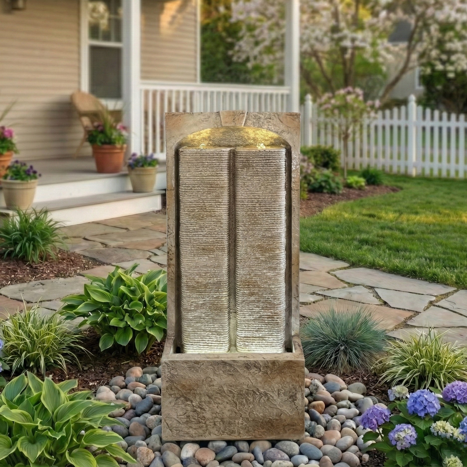split sandstone column fountain in front yard landscaping with flowers