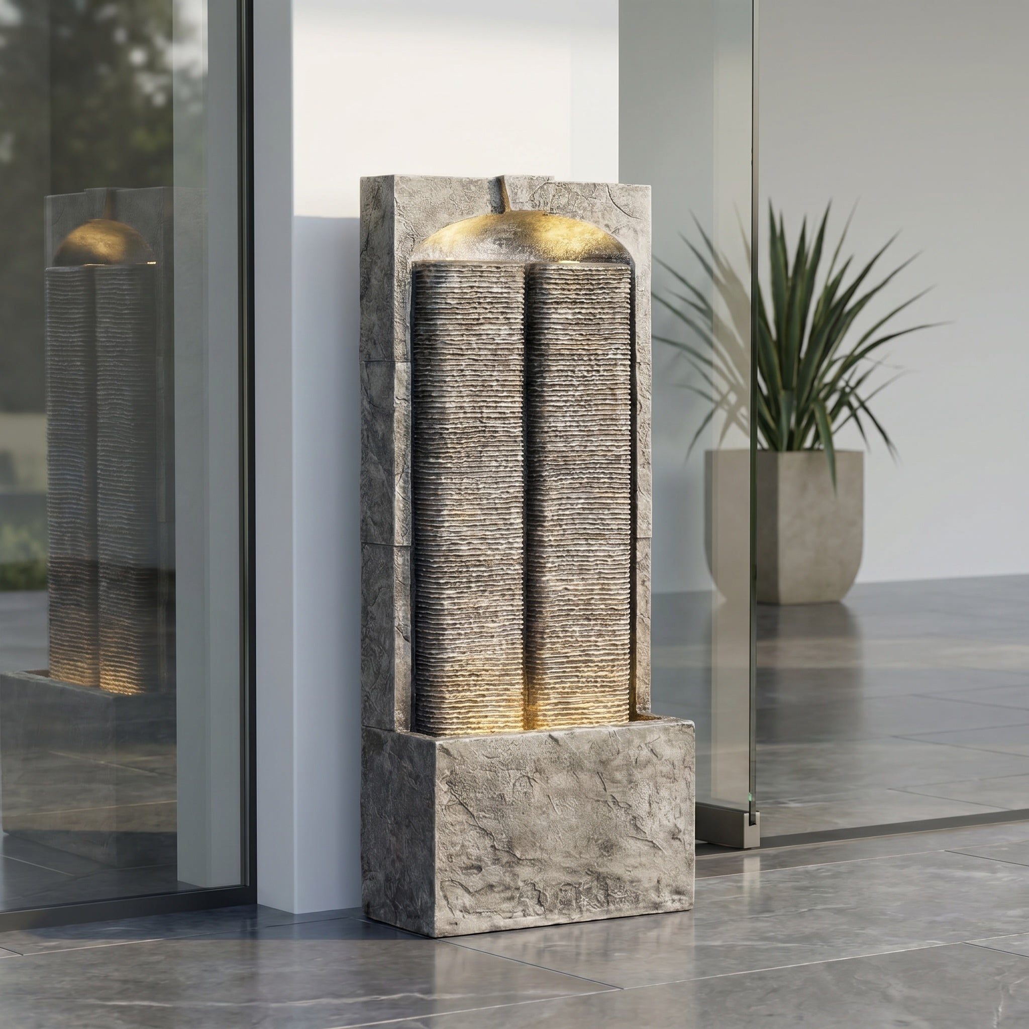 split slate column fountain by an entryway with potted plant