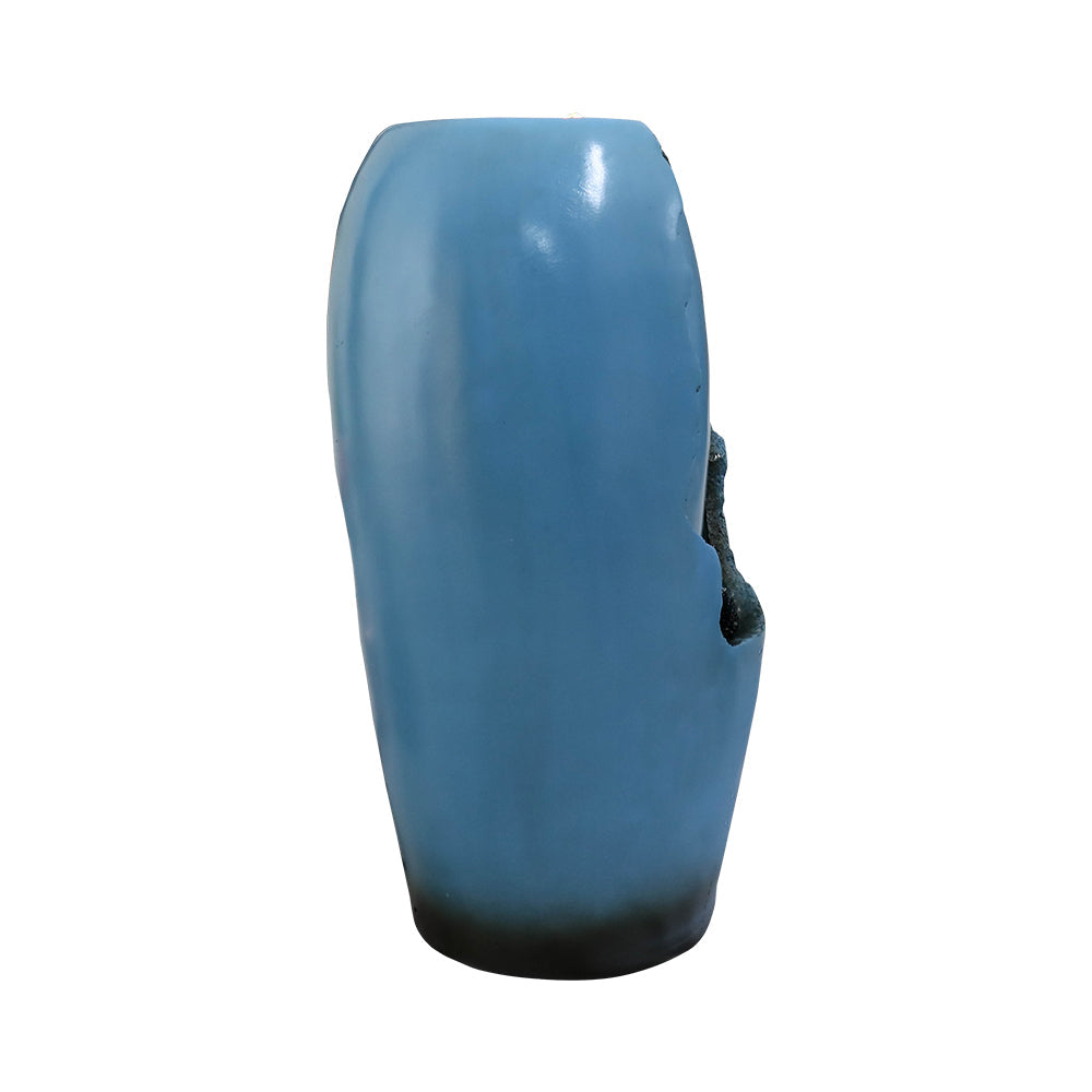 Side view of tall blue resin tabletop water fountain