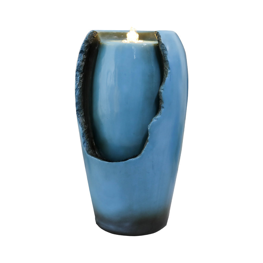Angled view of blue vase indoor water fountain and recessed water wall