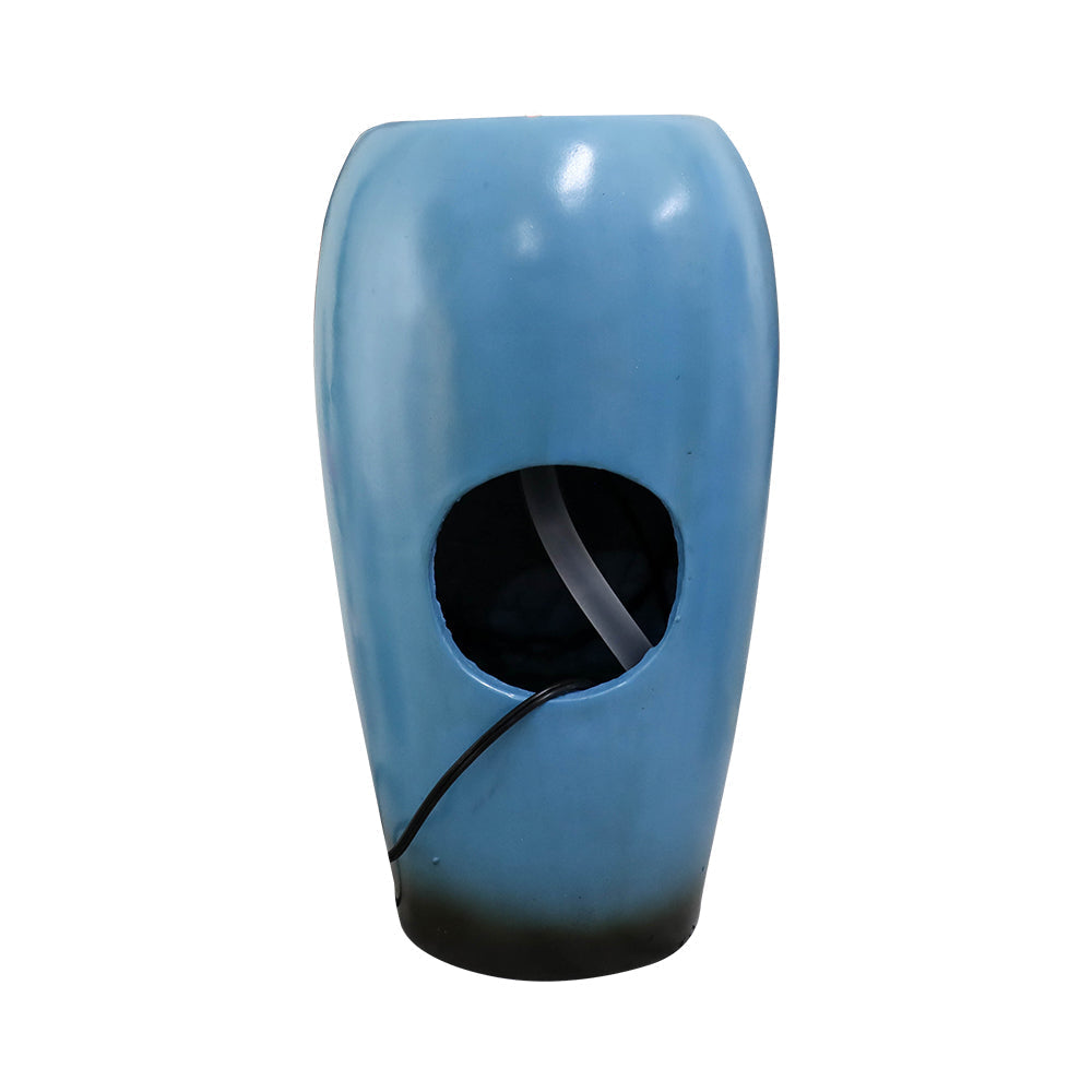 Rear pump access opening and power cord on blue vase indoor fountain
