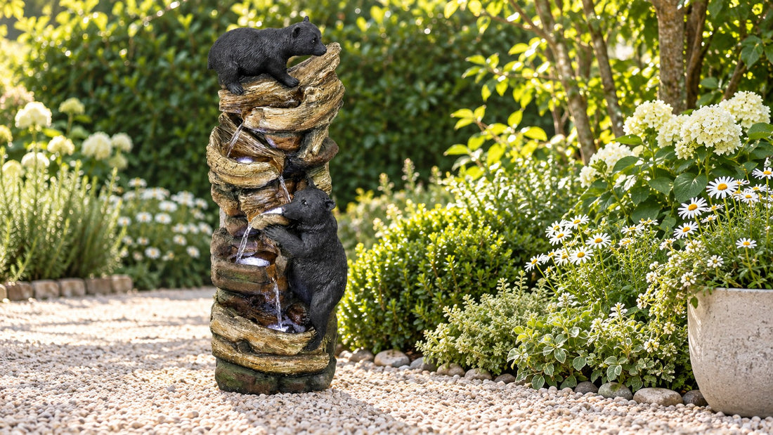 Tall stacked timber fountain with two black bear cubs, water stepping down several ledges beside a gravel path