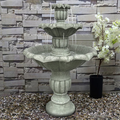 39.3"H concrete lotus fountain positioned against a textured backyard wall