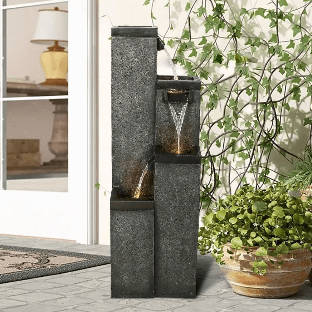 39.3 inch tall modern cement color 4-tier square pillar fountain in a contemporary garden