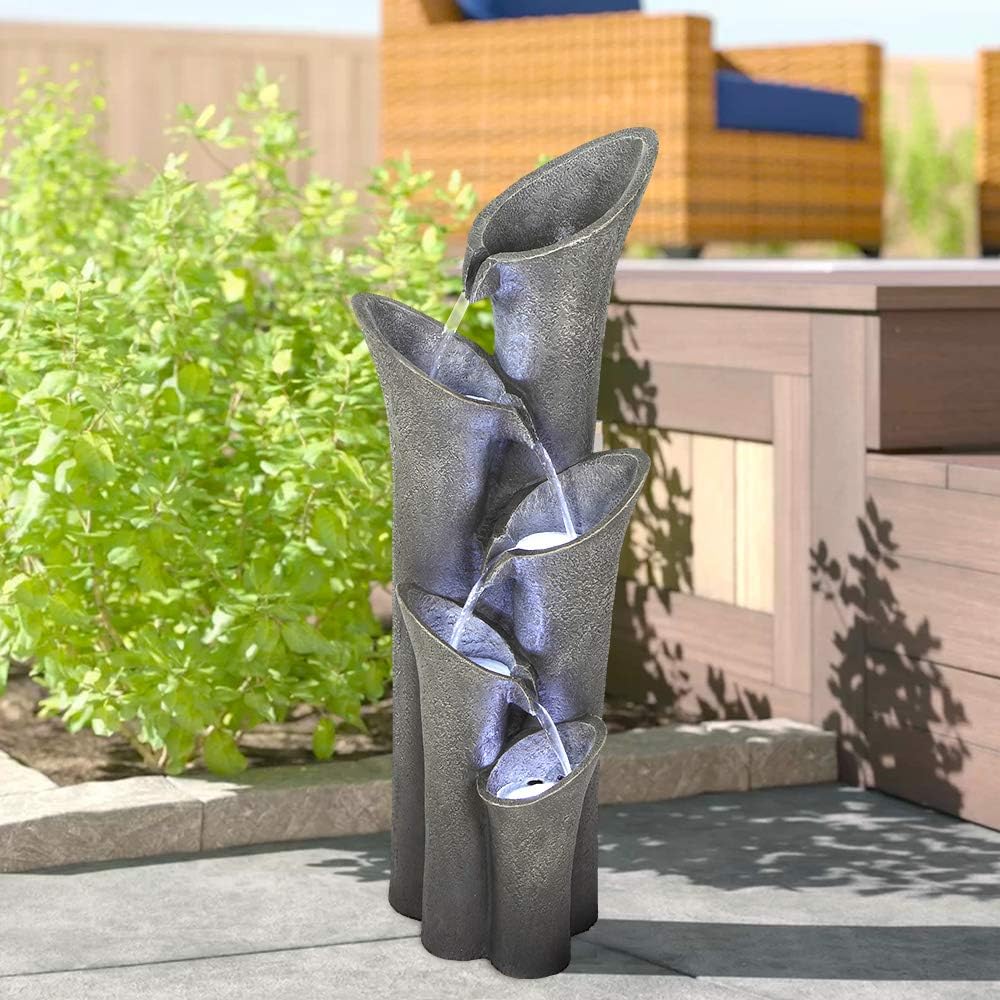 39.4"H faux stone outdoor fountain creating a tranquil atmosphere on a modern patio