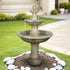51.5" tall modern round concrete outdoor fountain in a peaceful garden