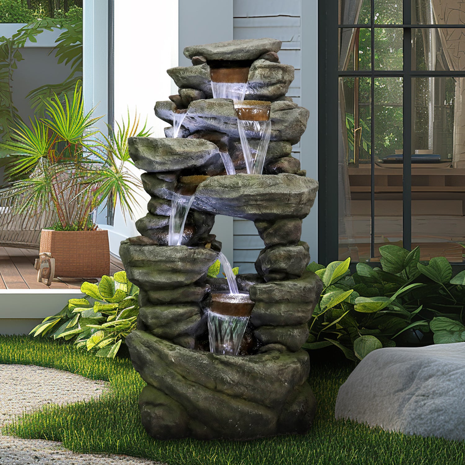 60"H cascading rock fountain with LEDs creating a relaxing ambiance on a modern patio.