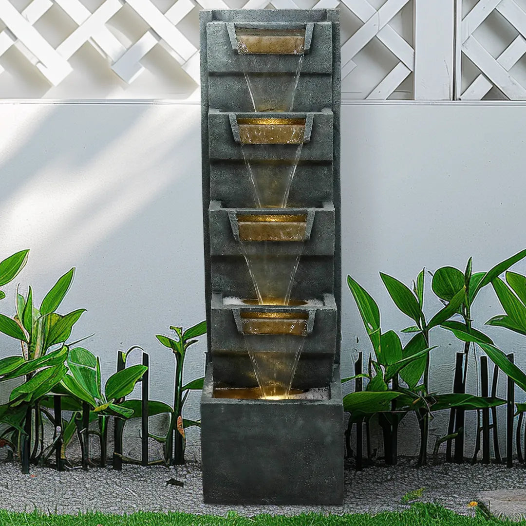 79-inch_tall_multi-tier_rock_cascading_fountain_against_a_white_garden_lattice_fence