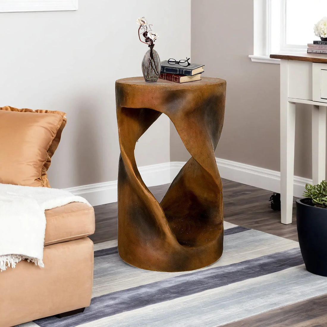Artistic spiral side table with a wood-look finish next to a sofa on a blue rug.