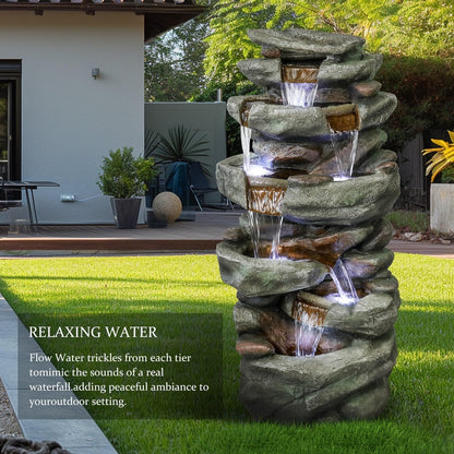 Cascading rock fountain outdoor blending seamlessly into a lush garden landscape