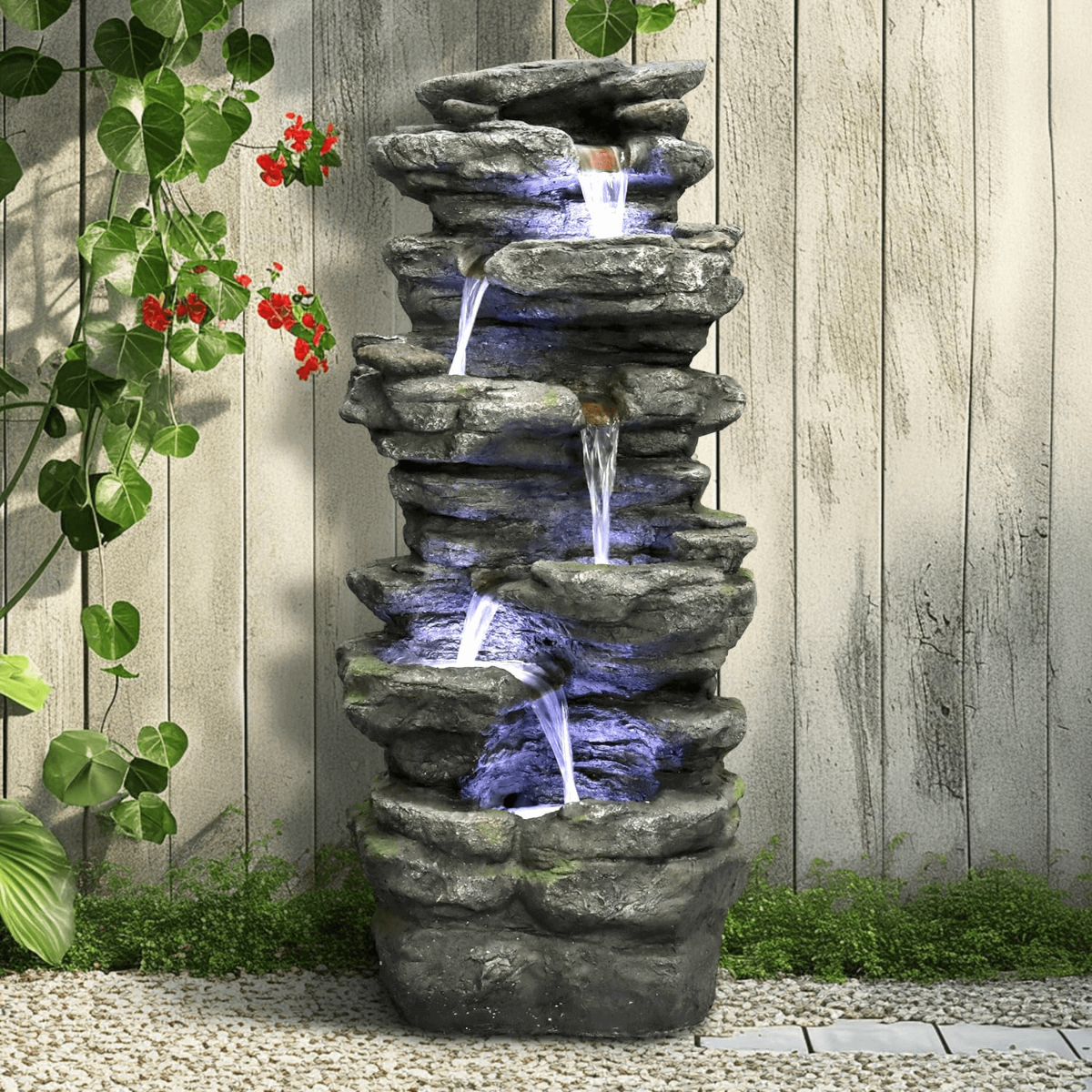Cascading rock waterfall fountain creating a relaxing oasis in a backyard patio