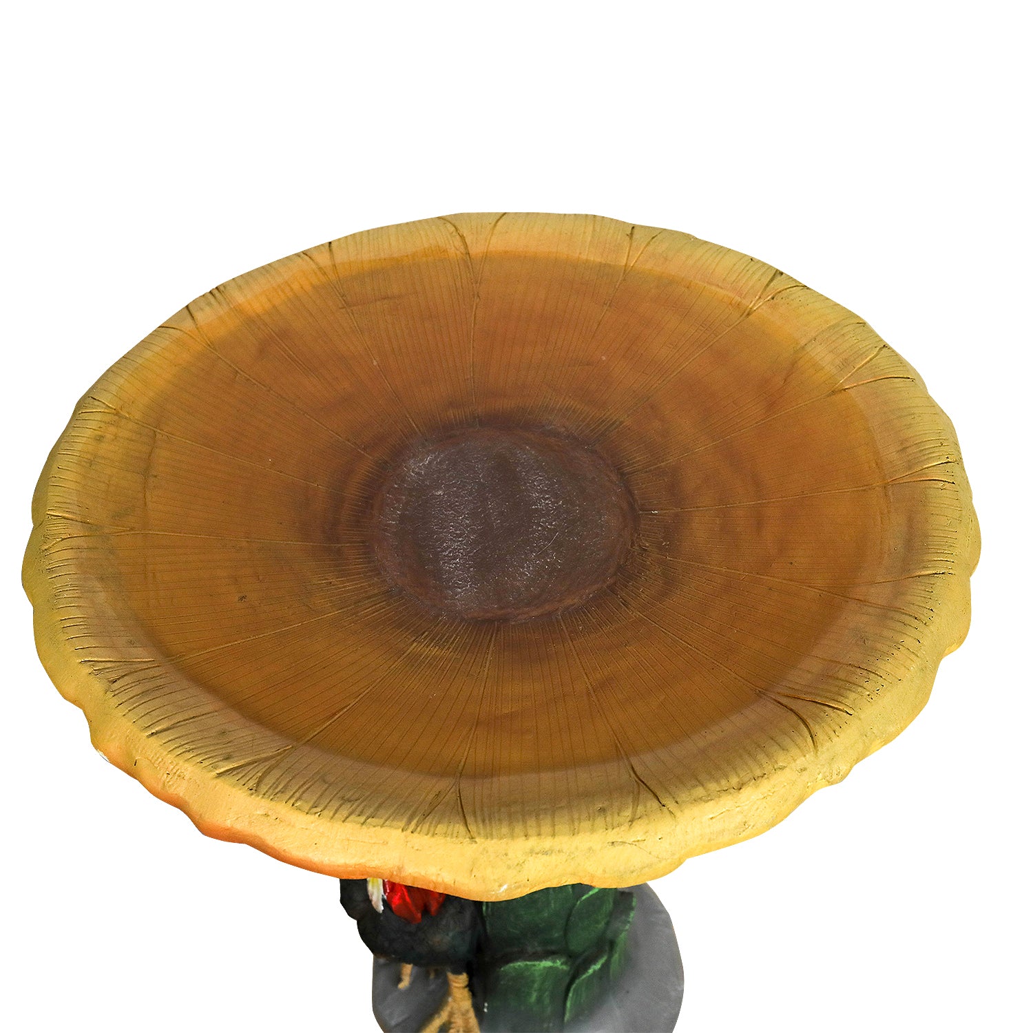 Close-up detail of the vibrant yellow sunflower bowl of the concrete bird bath.