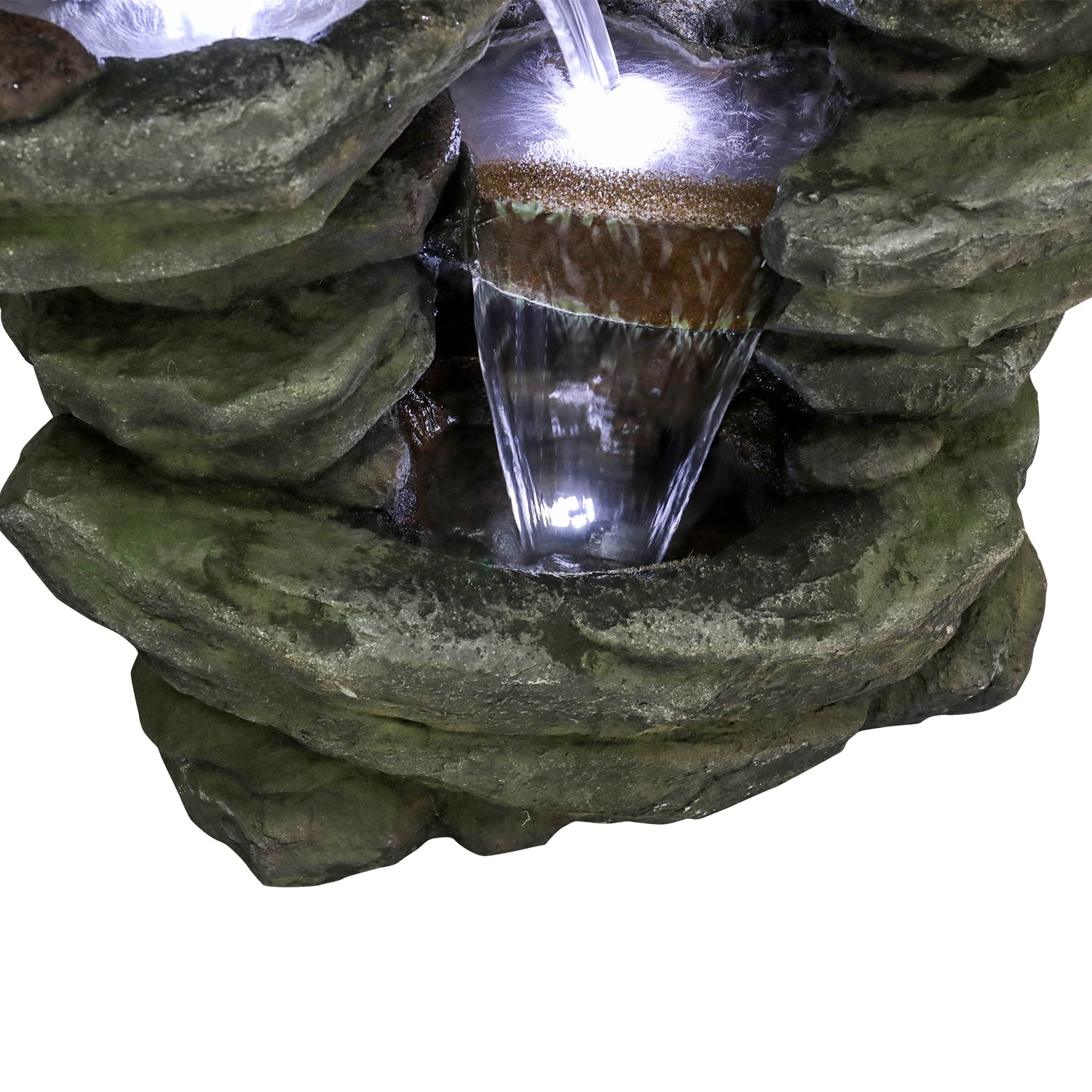 Close-up of the glowing white LED lights and trickling water in the rockery basin.