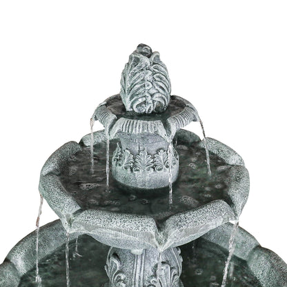 Close-up of the top finial and soothing water flow on the elegant classic outdoor fountain.
