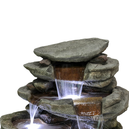 Close-up of the top rock tiers showing the natural stone look of the large outdoor fountain.