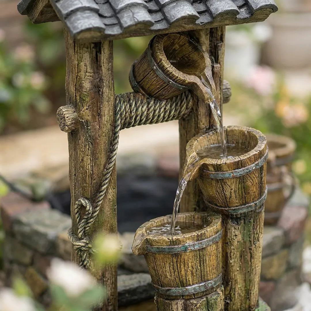 Close-up of water cascading over a highly realistic, rot-proof rustic barrel fountain.