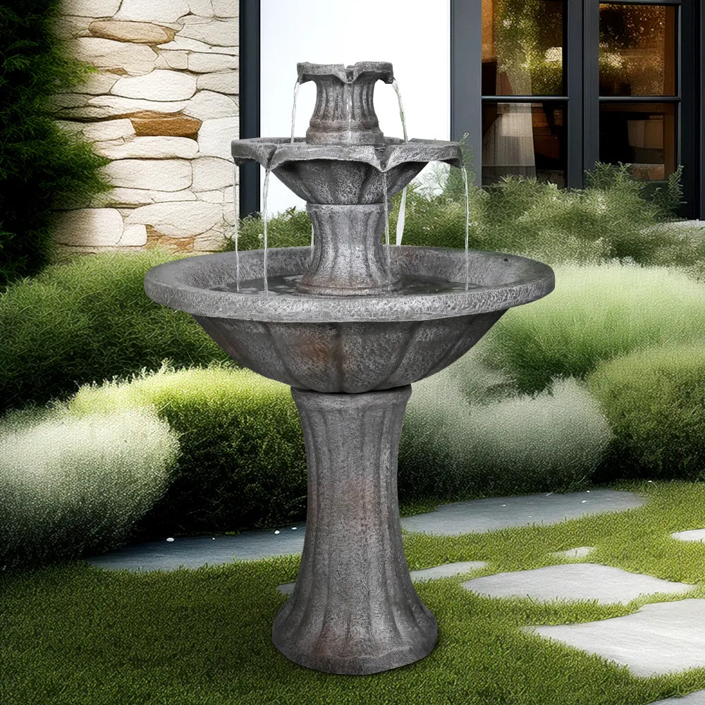 Dark castle design outdoor concrete waterfall on a green lawn