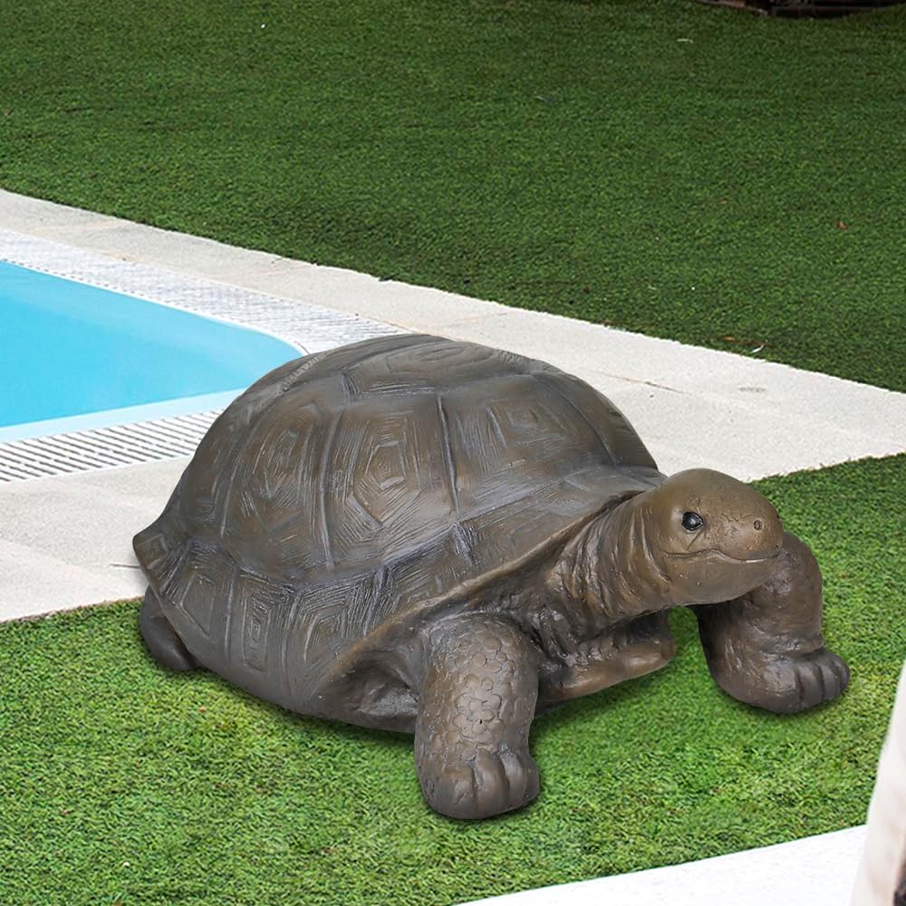 Dark gray concrete turtle garden decoration placed near a backyard pond