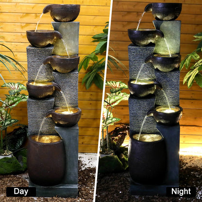 Day and night comparison of the 6-tier cascading fountain showing built-in warm LED illumination.