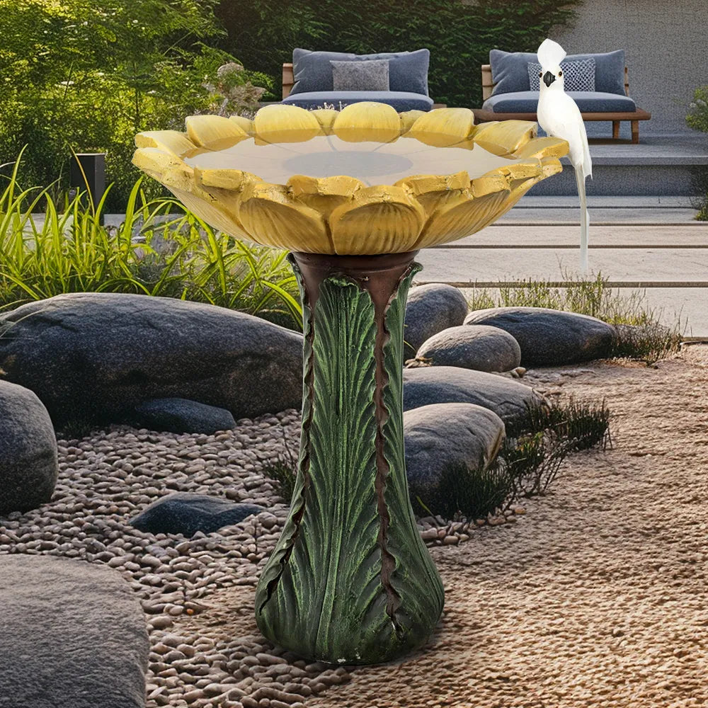 Decorative green leafy pedestal birdbath in a peaceful backyard