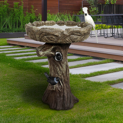 Decorative pedestal bird pond on a fresh lawn attracting birds