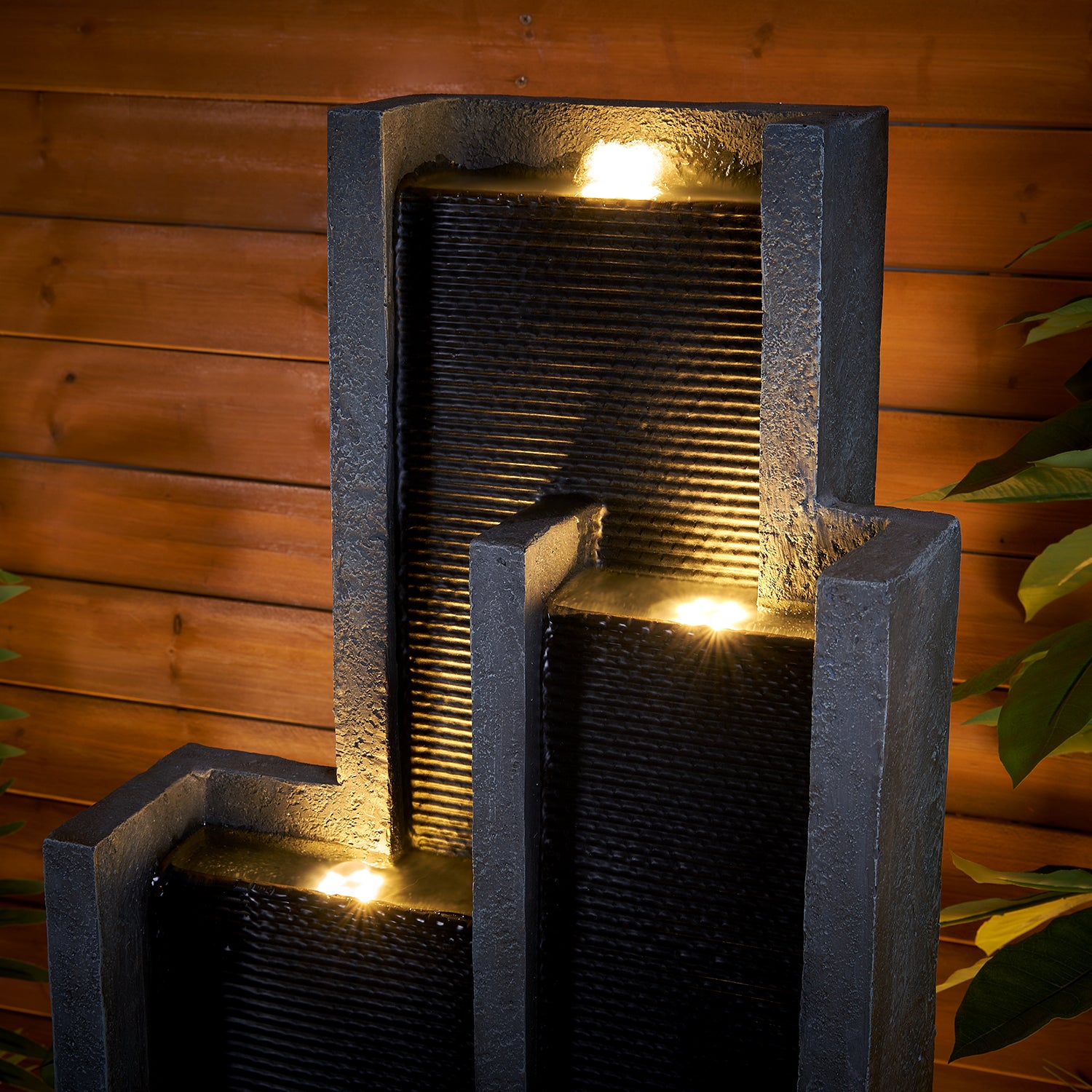 Detailed texture of the weatherproof natural stone look resin on the sleek cascading waterfall.