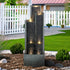 Elegant 50.7"H modern resin water fountain adding a calming sound whisper to a green garden.