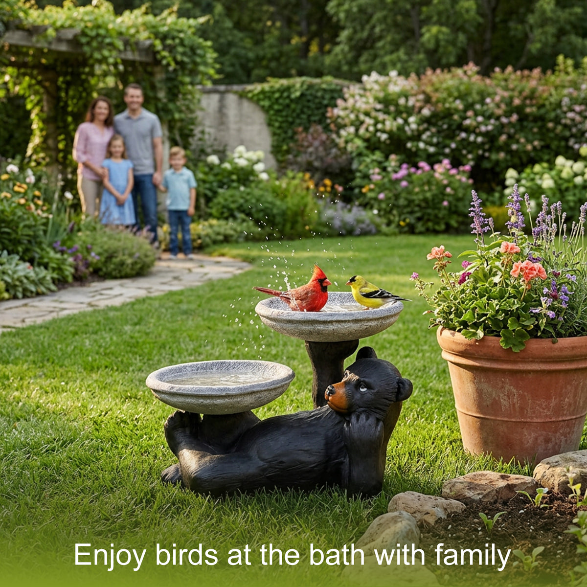 Family enjoying the sight of birds visiting the cute black bear bird bath on their lawn.