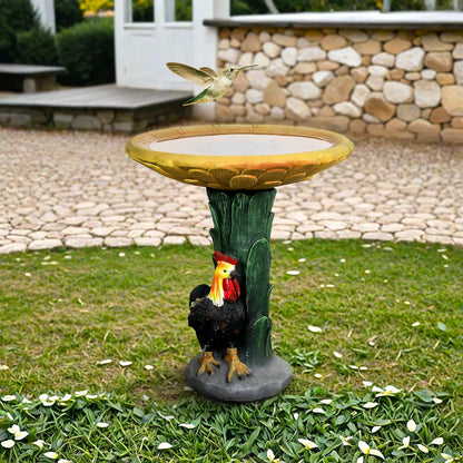 Freestanding rooster and chicken birdbath garden statue placed on a manicured lawn.