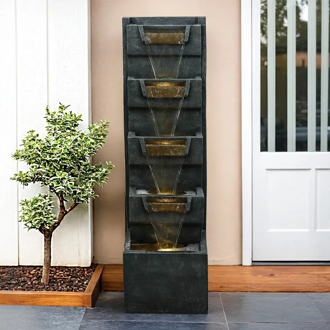 Giant realistic rock waterfall adding a tranquil soundtrack to a beautifully decorated garden porch