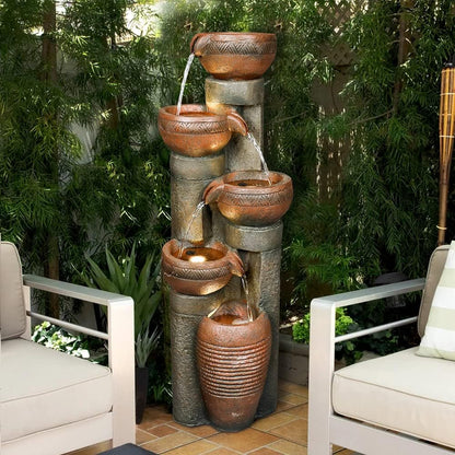 Lighted cascading column fountain serving as a centerpiece for a modern patio