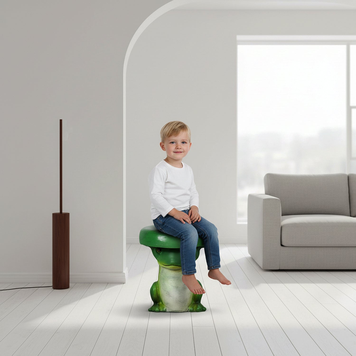 Little boy sitting safely on the cute green frog indoor stool in a bright, minimalist living room.