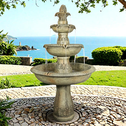 Majestic 3-tier concrete fountain with a panoramic view of the coastline in the background.