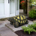 Realistic concrete turtle garden figurine placed as a welcome statue at a modern home entryway.