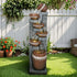 Rustic-bohemian6-tierwaterfallfountainplacedinalushgreengardensetting.