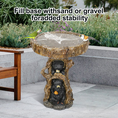 Rustic bear bird bath placed on a gravel patio